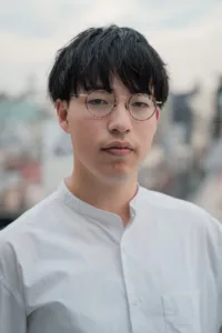 Professional portrait of a young man wearing glasses in Tokyo, ideal for corporate headshots and personal branding by JG.