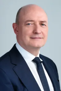 Professional headshot of a man in a dark suit by JG.