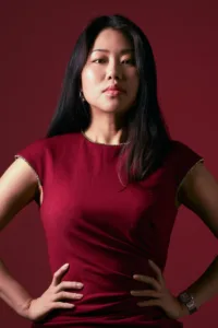 High-contrast portrait of a woman in a burgundy red dress, by Tokyo photographer JG.